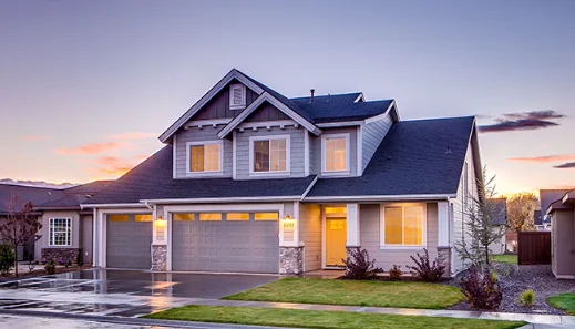 A two-story suburban home with a front lawn and attached garage